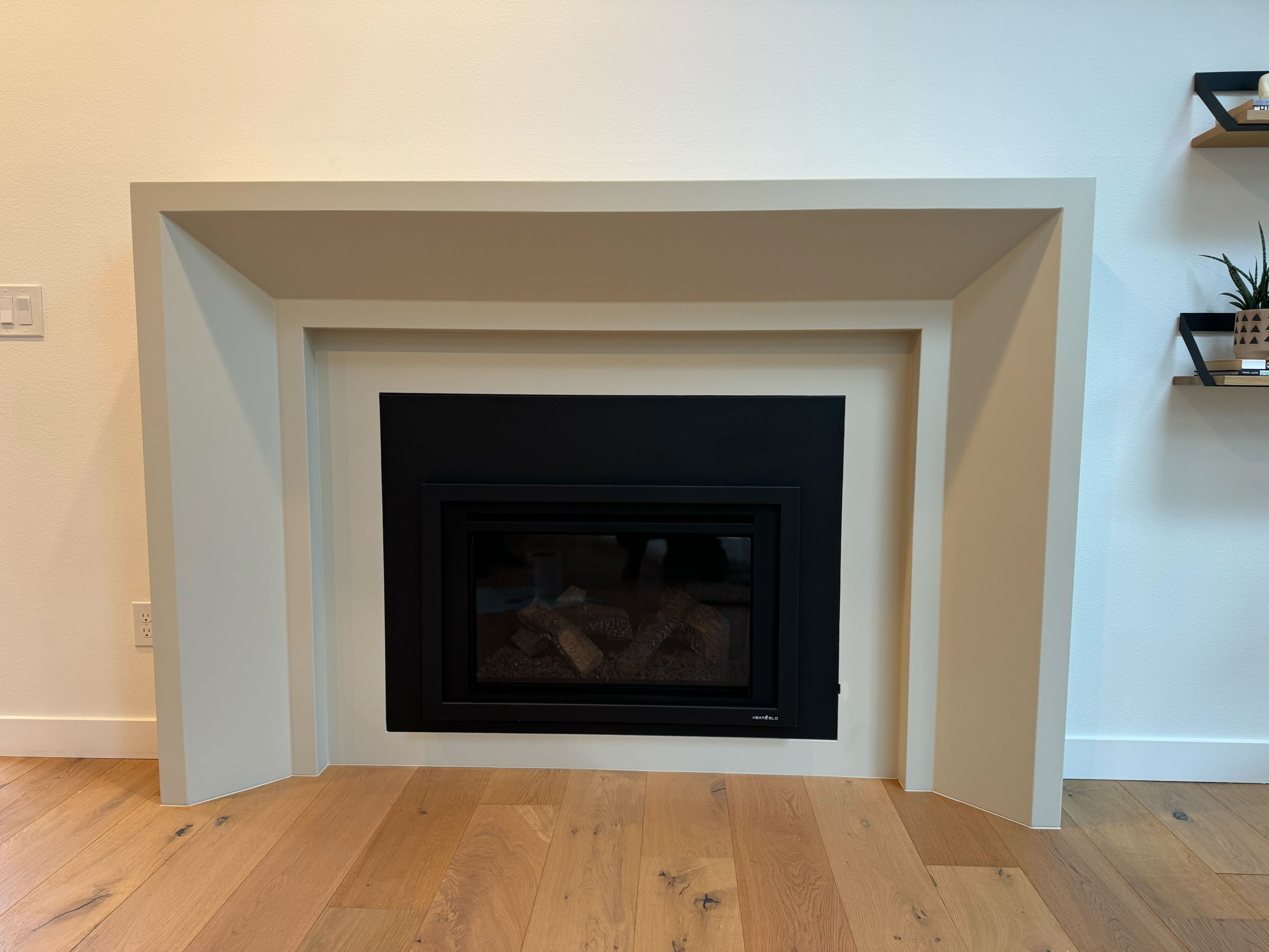 Newport cast limestone mantel and surround — installed product photo
