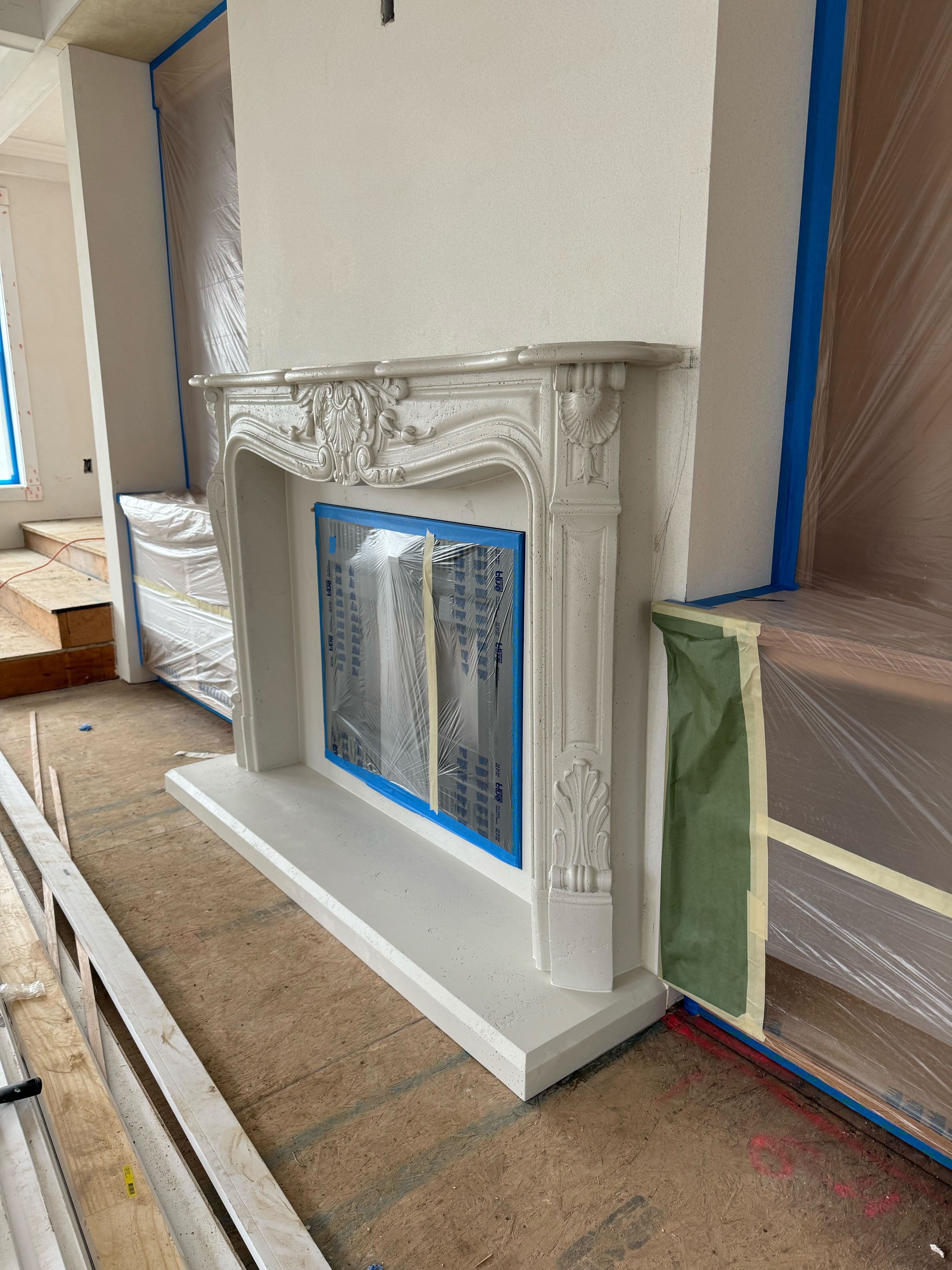 Louis XV cast stone fireplace surround — installed product photo