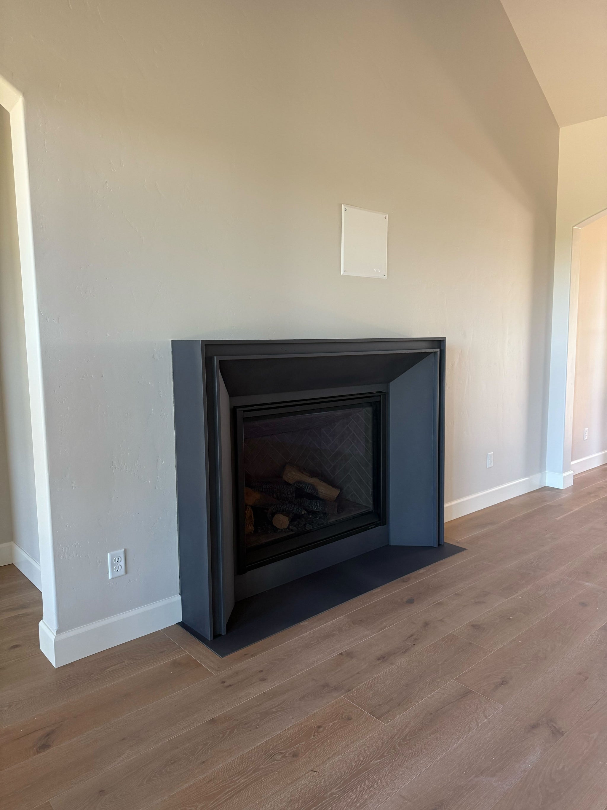 Lucca cast limestone fireplace surround installed at a clients home