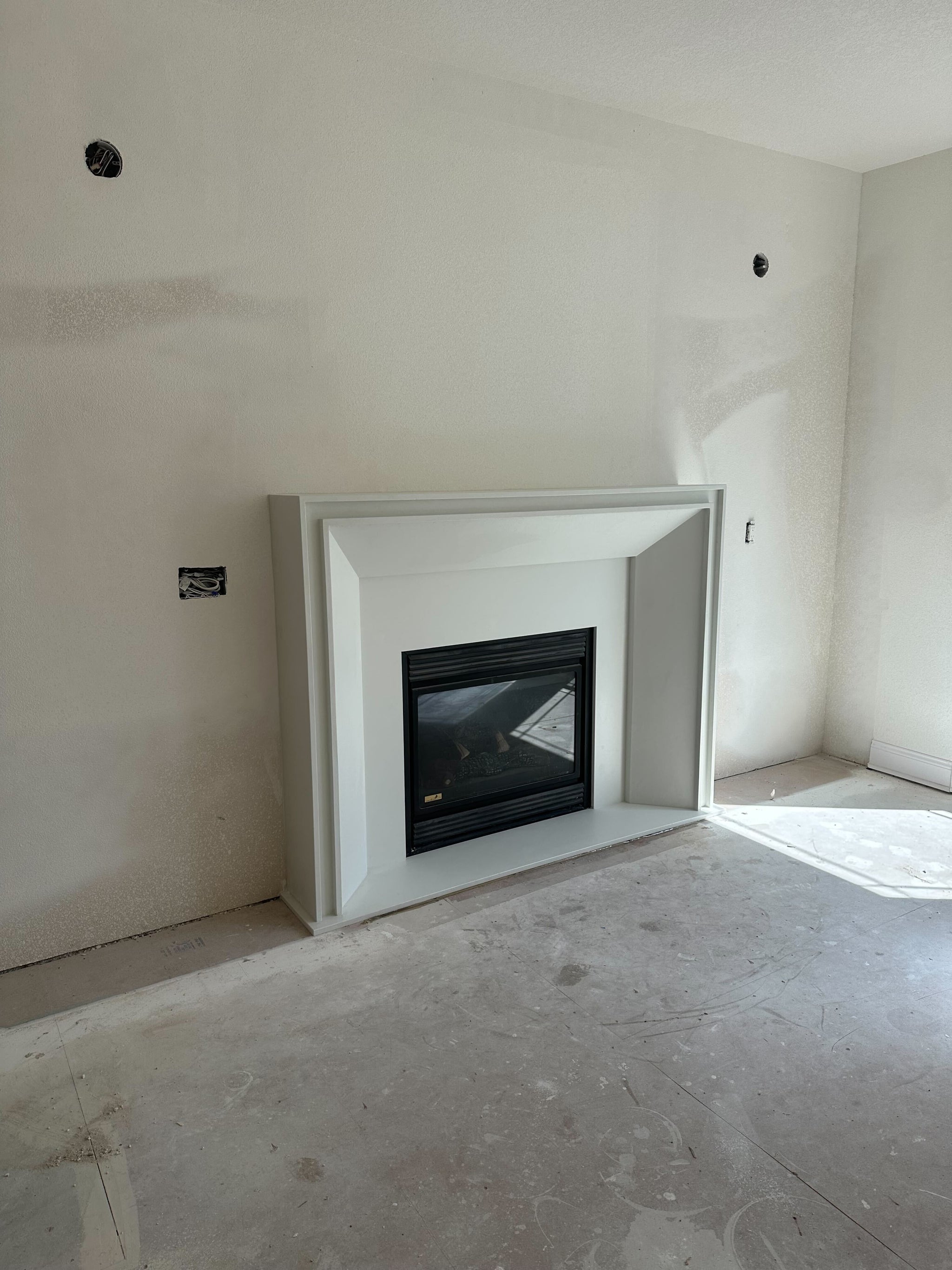 Lucca cast limestone fireplace surround installed at a clients home