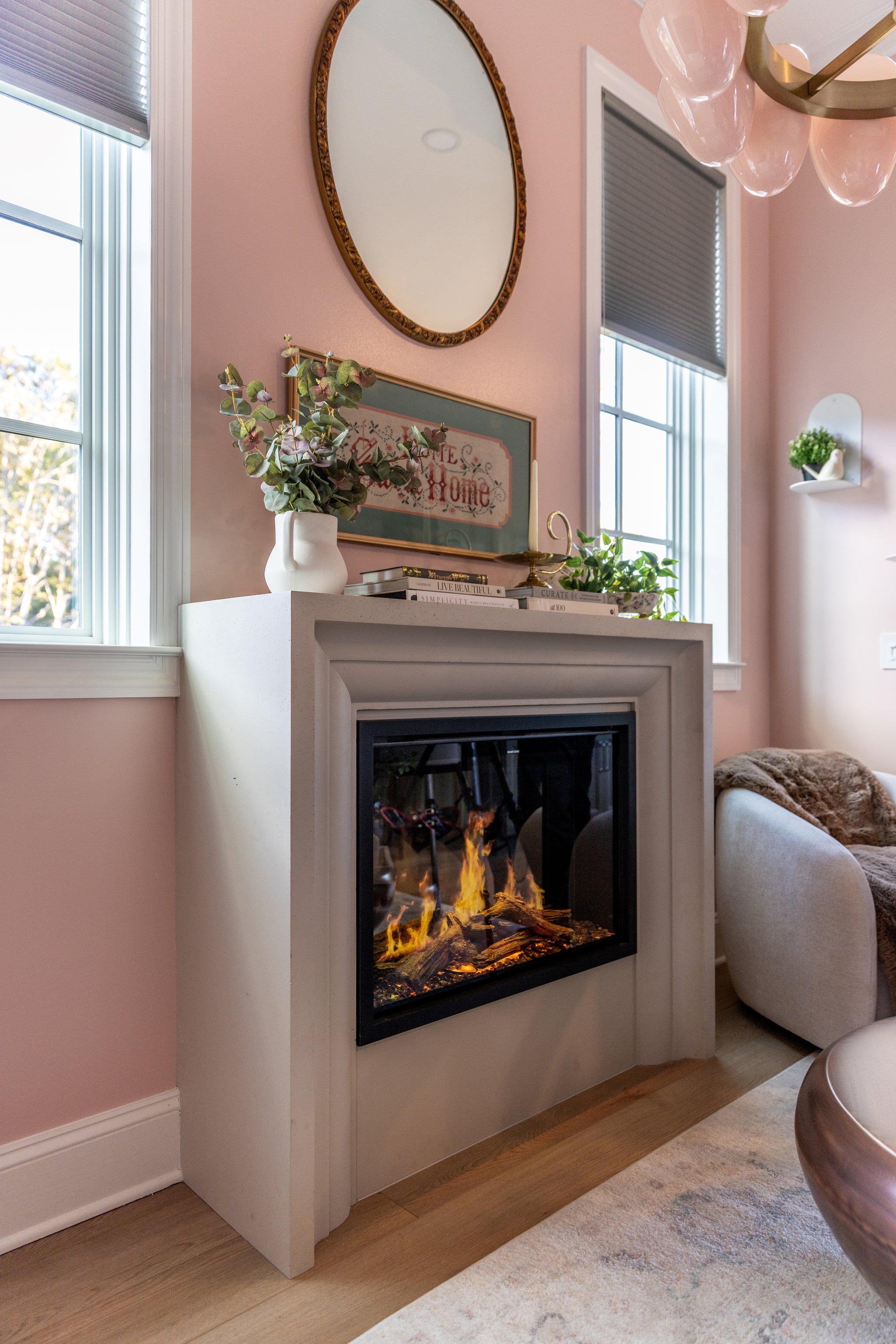 Amalfi cast stone fireplace surround installed in a finished home — photography by Wade Works Creative