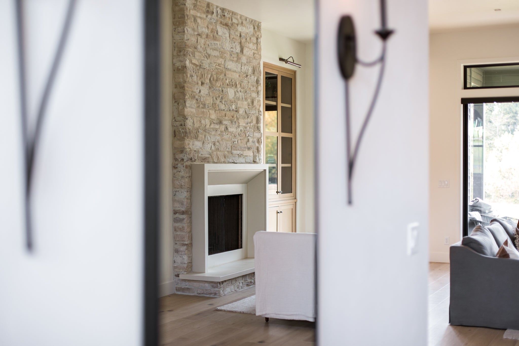 Milan cast limestone fireplace surround installed in a finished living space