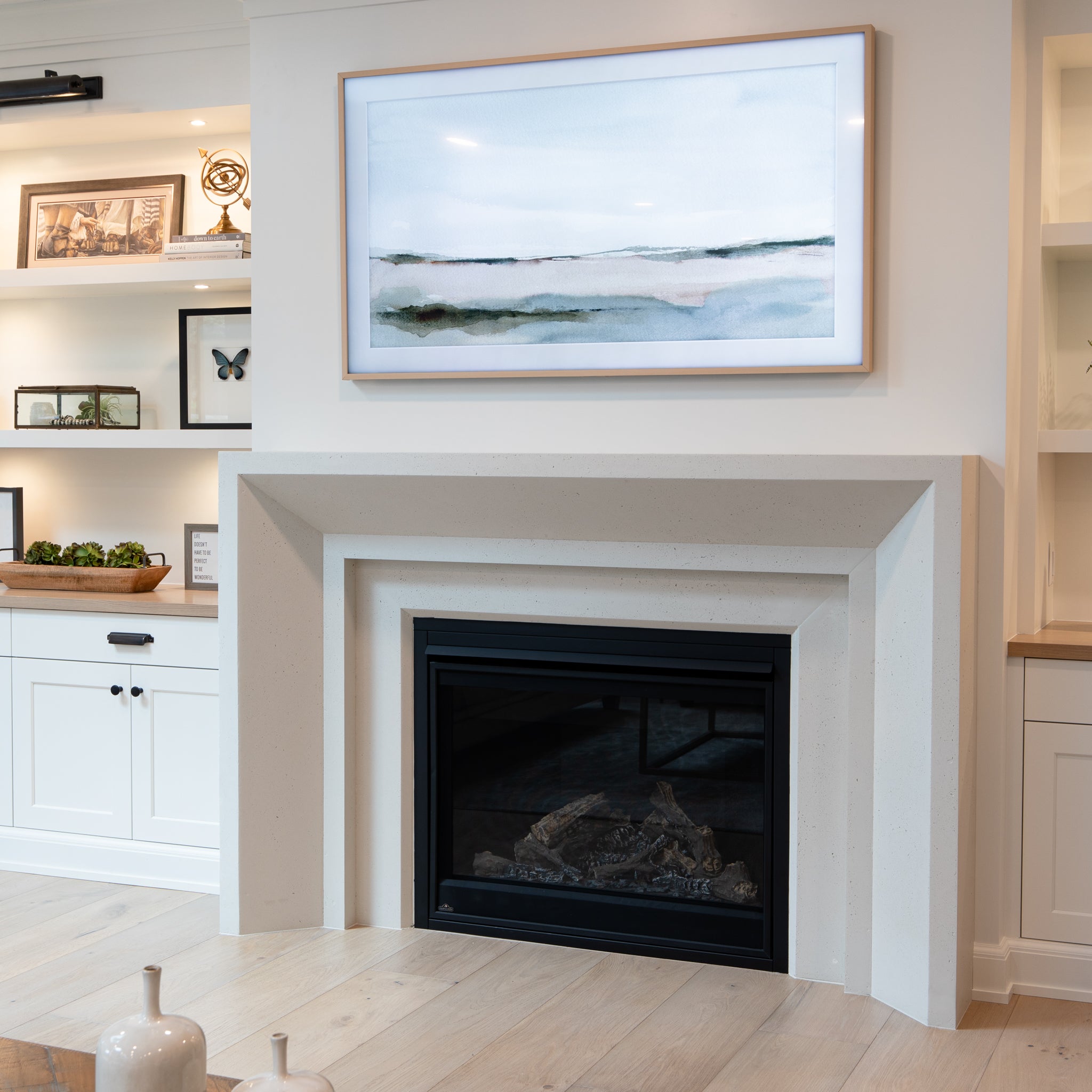 Newport cast stone fireplace surround in a bright, modern living room.