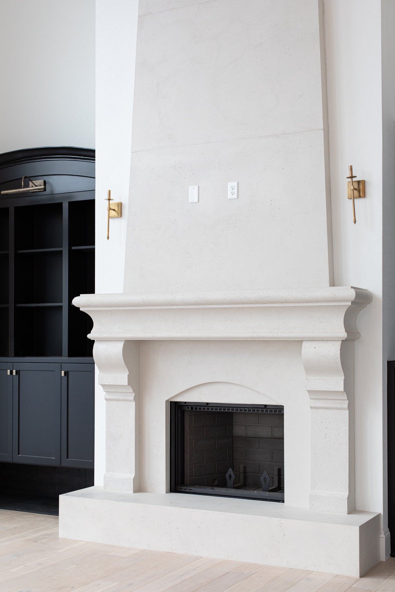 Petite Tuscan cast limestone fireplace surround installed at the Pickette residence